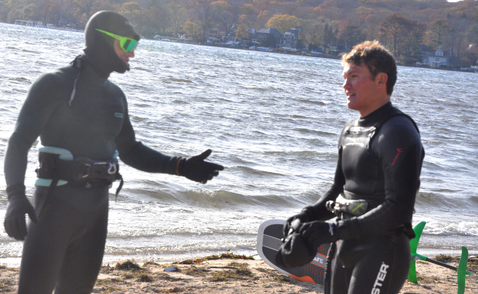 Charlie Vogel, left, and Harry Melges discuss their day of kite boarding on Geneva Lake at Riviera Beach